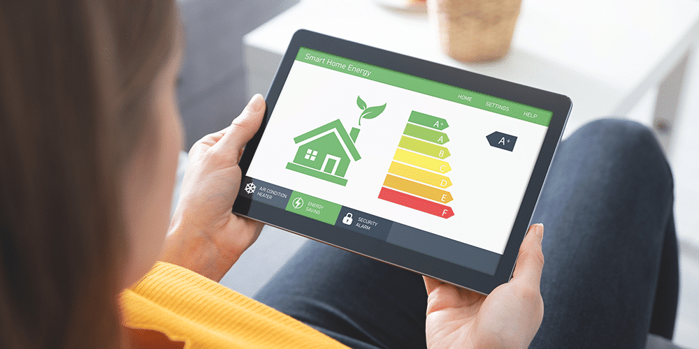 Female homeowner looks at tablet displaying energy efficiency stats for her home.