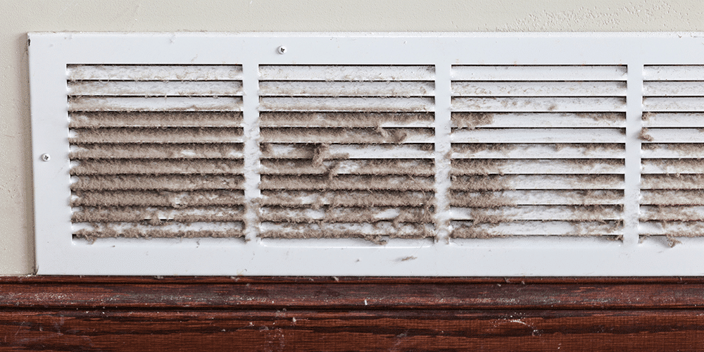 How to Get Rid of Dust Shot of a vent cover clogged with dust, dirt, and other contaminants.