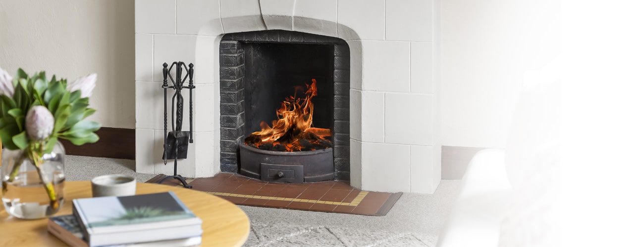 Fire roars in residential fireplace installed by ComfortAire